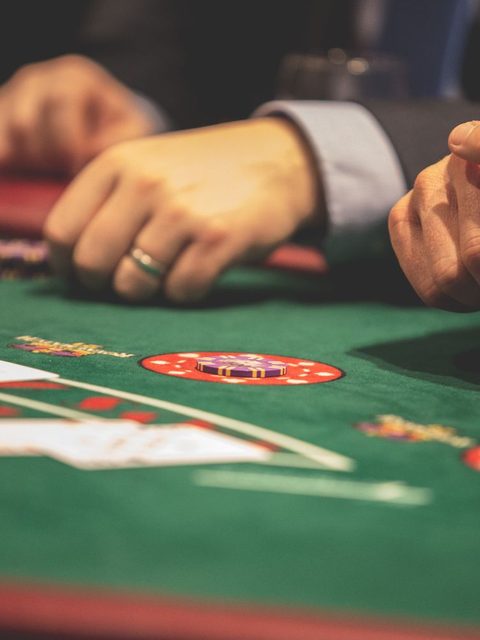 Close-up of a roulette wheel under warm casino lighting.