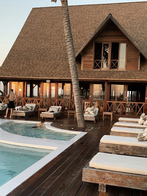 A resort hotel illuminated at dusk, ready for an evening visit.